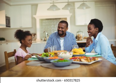 Happy family having meal on dinning table at home