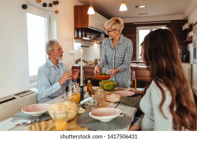Happy family having a meal together - Shutterstock ID 1417506431