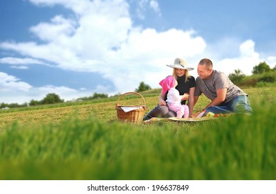 Happy Family Having A Picnic In The Park