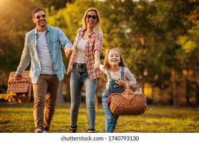 Happy Family Having Picnic In Park.Young Happy Family Of Three Having Fun Together.Family Fun Outside.