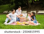 Happy family having picnic together in park