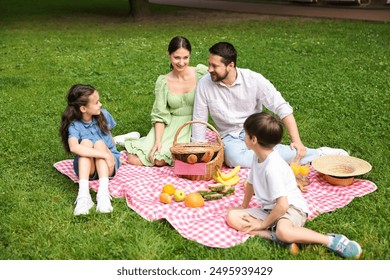 Happy family having picnic together in park - Powered by Shutterstock