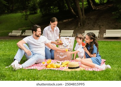 Happy family having picnic together in park - Powered by Shutterstock