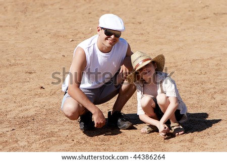 Similar – Vater und Sohn sitzen im Park.