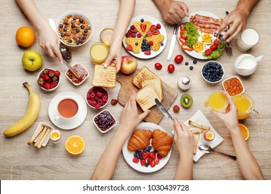 Happy Family Having Tasty Breakfast In The Morning