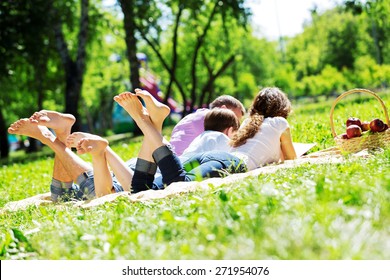 Happy Family Having Weekend In Summer Park