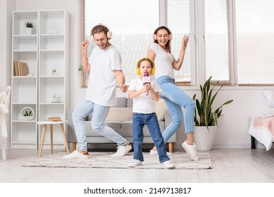 Happy Family With Headphones And Microphone Singing Song At Home