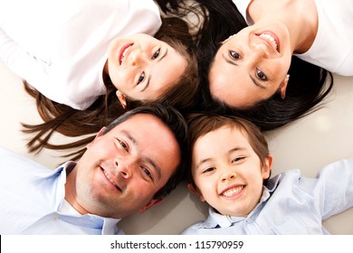 Happy Family With Heads Together On The Floor