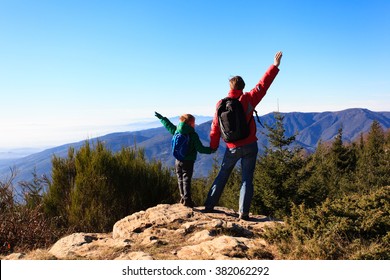 Happy Family Hiking In Scenic Mountains