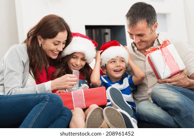 Happy Family Holding Christmas Gift