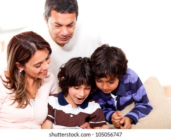 Happy Family At Home Reading A Book Together