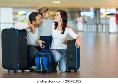 Happy Family Hugging At Airport