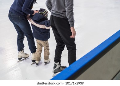 Happy Family Indoor Ice Skating At Rink. Winter Activities