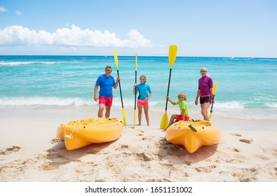 Happy Family With Kayaks At The Tropical Beach During Summer Vacations. Summer, Sea , Sport And Fun .