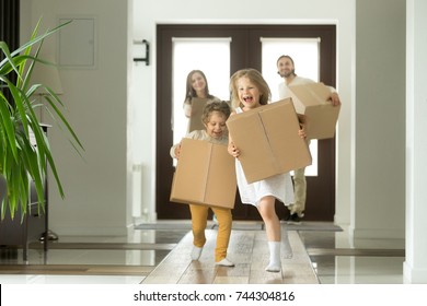 Happy family with kids bought new home, excited children funny girl and boy holding boxes running into big modern house, helping parents with belongings, moving day concept, mortgage and relocation  - Powered by Shutterstock