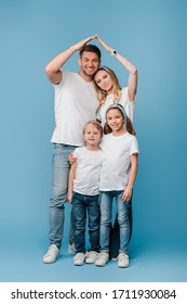 Happy Family With Kids Making Roof Gesture Over Heads On Blue