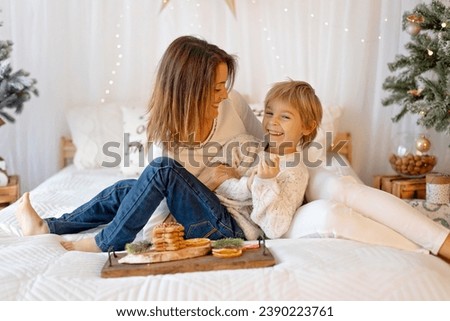 Similar – child girl playing checkers with her dad at home