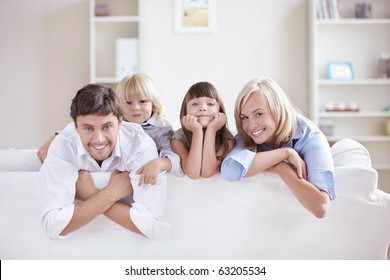 A happy family with kids on the couch