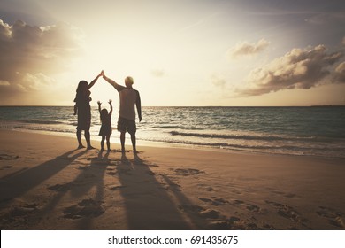 Happy Family With Kids Play At Sunset Beach