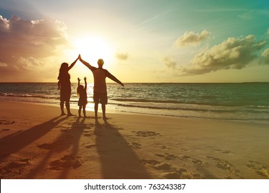 Happy Family With Kids Play At Sunset Beach