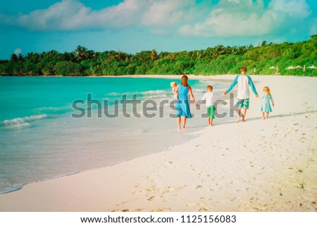 happy family with kids walk on tropical beach