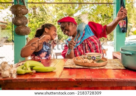 Happy Family In Kitchen. Black Mother And Little grandaughter Preparing lunch together, Loving African American Mom Teaching Her Child Cooking, Enjoying Spending Time With Kid. Stock foto © 