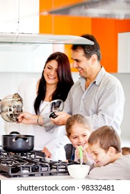 Happy Family In The Kitchen Cooking Dinner Together