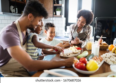 Happy Family In The Kitchen Having Fun And Cooking Together. Healthy Food At Home.