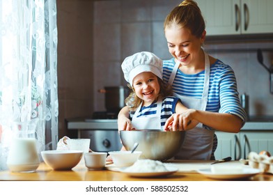 happy family in the kitchen. mother and  child daughter preparing the dough, bake cookies
 - Powered by Shutterstock