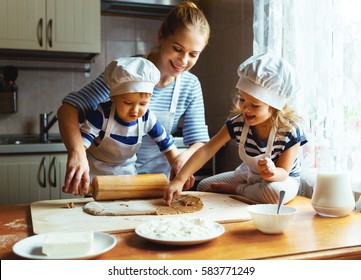 happy family in the kitchen. mother and  children preparing the dough, bake cookies - Shutterstock ID 583771249