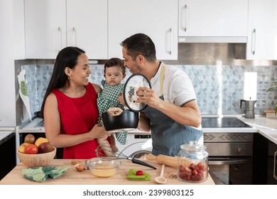 happy family in the kitchen while doing housework together - Powered by Shutterstock