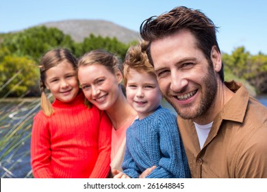 Happy Family At A Lake In The Countryside