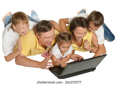 Happy Family With Laptop On A Floor