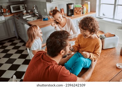 Happy family laughing having fun in the kitchen - Powered by Shutterstock