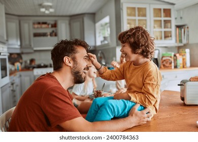 Happy family laughing having fun in the kitchen - Powered by Shutterstock