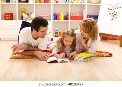 Happy Family Laying On The Floor Reading In The Kids Room