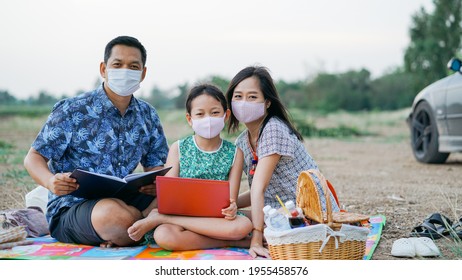 Happy Family Learning By Laptop And Having A Picnic In Outdoor With Wearing Face Mask