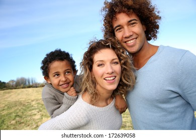 Happy family with little boy in countryside