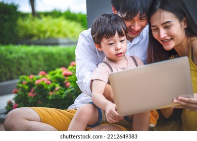 Happy Family With Little Boy Using Technologies Laptop Summer Outdoors At Home, Technology Communication Lifestyles Concept.