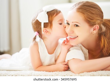 happy family.  Little child girl kisses her mom