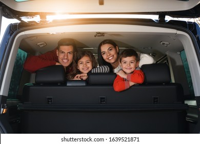 Happy Family With Little Children Inside Modern Car