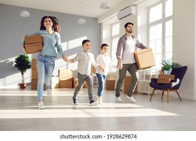 Happy family with little kids running to explore new home. Parents and children holding hands as they enter newly bought house or apartment on moving day. Real estate business and mortgage concept - Powered by Shutterstock