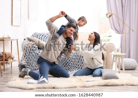 Happy family with little son having fun at home. Winter vacation