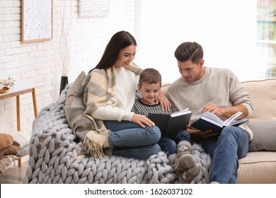 Happy Family With Little Son Reading Books At Home. Winter Vacation