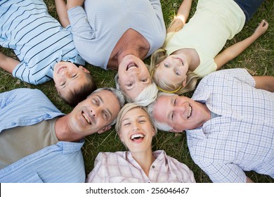 Happy family looking up the camera on a sunny day - Powered by Shutterstock