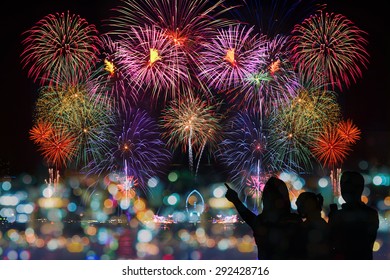 The Happy Family Looks Celebration Fireworks On The Night Sky