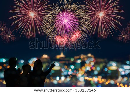 The happy family looks celebration fireworks in the night sky 