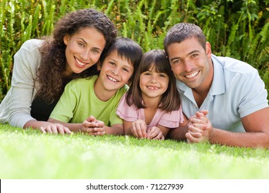 Happy family lying down in the garden