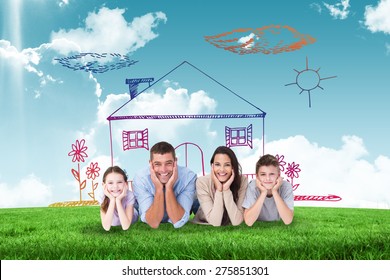 Happy family lying and head in hands against blue sky over green field