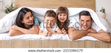 Similar – Children feeding doll with cookie sitting over the bed